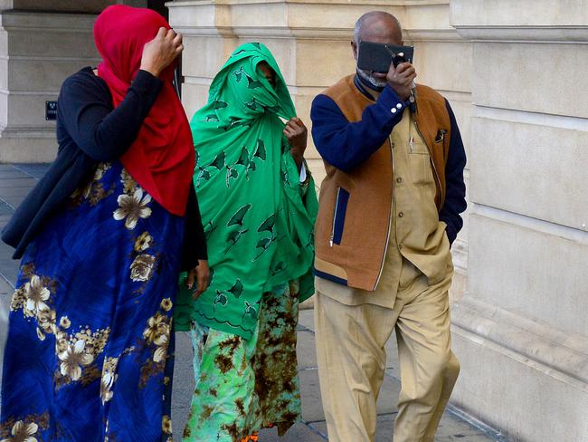 Zainab Abdirahman-Khalif’s supporters cover their faces as they leave court. Picture: AAP / Sam Wundke