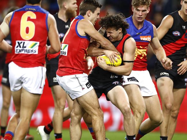 GOLD COAST, AUSTRALIA - JULY 31: Jarrod Berry of the Lions tackles Andrew McGrath of the Bombers during the round nine AFL match between the Essendon Bombers and the Brisbane Lions at Metricon Stadium on July 31, 2020 in Gold Coast, Australia. (Photo by Ryan Pierse/Getty Images)