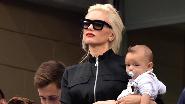 Mum...Gwen Stefani holds son Apollo as she watches Roger Federer and Marin Cilic during their US Open semifinal on Sept 6. Picture: AFP