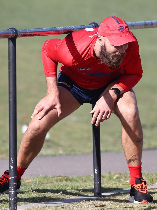 Max Gawn tests his knees out ducking under a fence. Picture: Michael Klein.