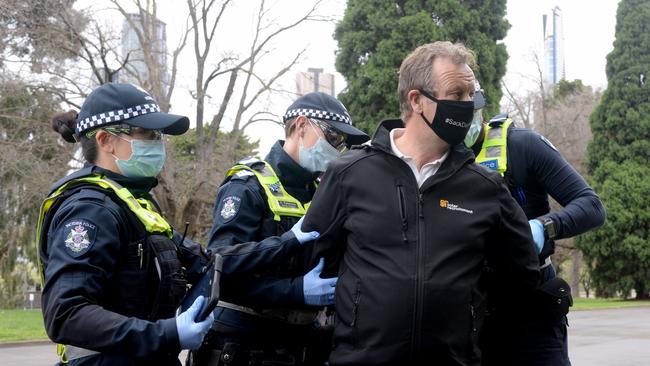 Police arrest a demonstrator at the anti-lockdown protest near the Shrine of Remembrance. Picture: Andrew Henshaw