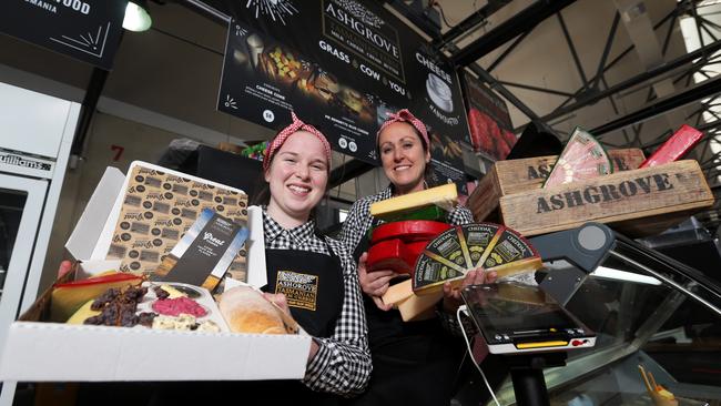 Jess Wall and Anne Bennett from Ashgrove Cheeses putting the finishing touches on their stall at the Taste of Tasmania Picture: Luke Bowden