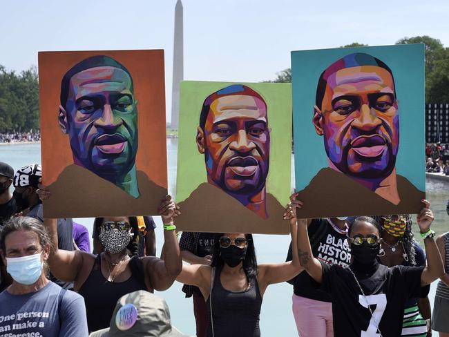 WASHINGTON, DC - AUGUST 28: Attendees hold images of George Floyd as they participate in the March on Washington at the Lincoln Memorial August 28, 2020 in Washington, DC. Today marks the 57th anniversary of Rev. Martin Luther King Jr.'s "I Have A Dream" speech at the same location.   Drew Angerer/Getty Images/AFP == FOR NEWSPAPERS, INTERNET, TELCOS & TELEVISION USE ONLY ==