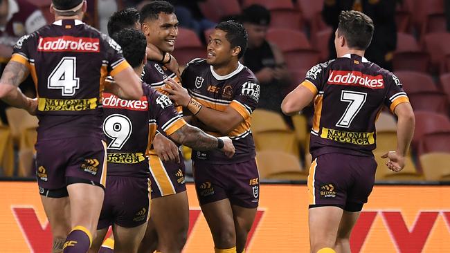 Tevita Pangai Jr celebrates with teammates after scoring a try.