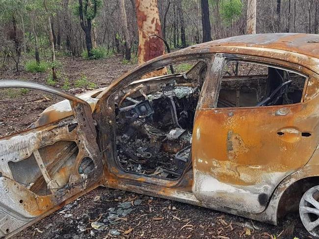 The charred remains of a stolen red Mazda 2 allegedly taken from Yeppoon.