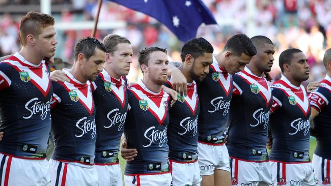 The Roosters line up for a minute’s silence in their Anzac Day match with the Dragons in 2014.