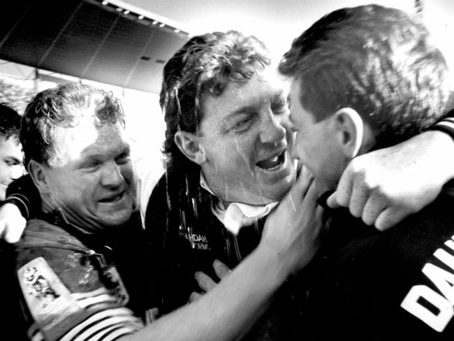 Penrith juniors Brad Izzard (left) and Greg Alexander (right) celebrate with coach Phil Gould after the 1991 victory.