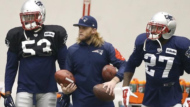 New England Patriots coaching assistant Steve Belichick holds footballs as New England Patriots strong safety Tavon Wilson (27) and linebacker Eric Martin (53) prepare to practice in Foxborough.