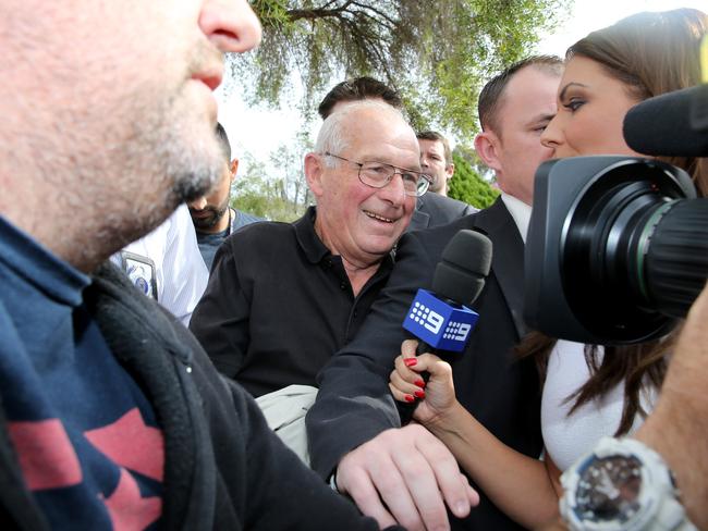 REAL MEDIA SCRUM: Reporters converge on Rogerson during his arrest.