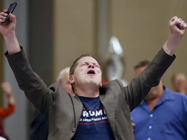 Trump supporter Grant Bynum raises his hands after hearing the news Donald Trump won Ohio in the Presidential election. Picture: Jae S. Lee/The Dallas Morning News via AP