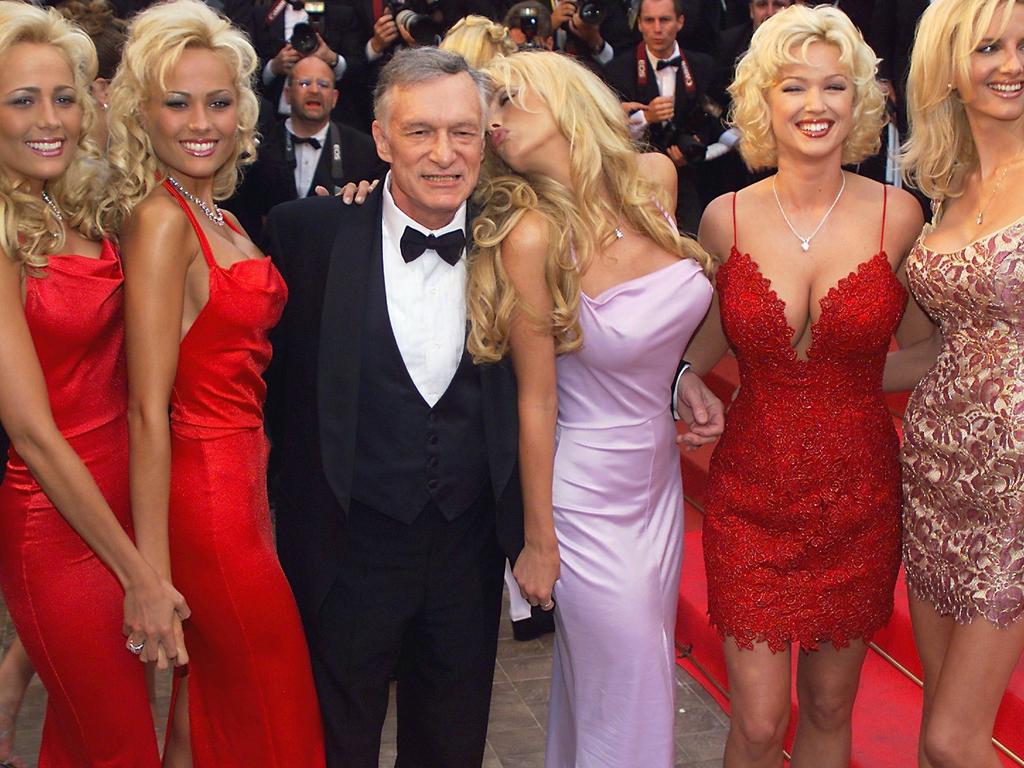Playboy magazine president Hugh Hefner poses with playmates. He allegedly destroyed a cement chest of incriminating A-list sex tapes before his death. Picture: Supplied