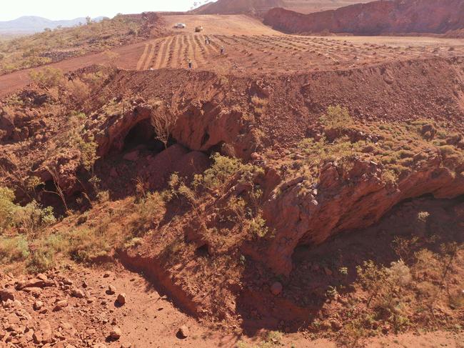 This handout photo taken on May 15, 2020 and released by the PKKP Aboriginal Corporation and recieved by AFP on May 27, 2020 shows Juukan Gorge in Western Australia -- one of the earliest known sites occupied by Aboriginals in Australia. - Anglo-Australian mining giant Rio Tinto has admitted damaging ancient Aboriginal rock shelters in the remote Pilbara region -- blasting near the 46,000-year-old heritage site to expand an iron ore mine. (Photo by Handout / PKKP Aboriginal Corporation / AFP)