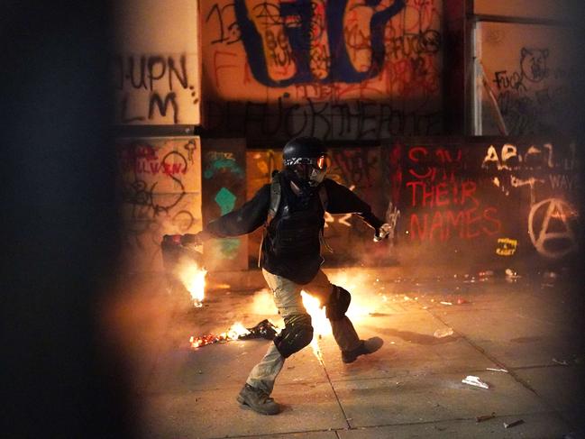 A protester throws flaming trash during riots in Portland, Oregon. Picture: AFP