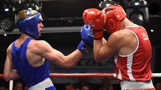 Kieran Rocke lands a blow on Beau Budak in a boxing match.