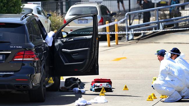 Forensic police tag the crime scene, including the car Mick Hawi was shot inside. Picture: Toby Zerna