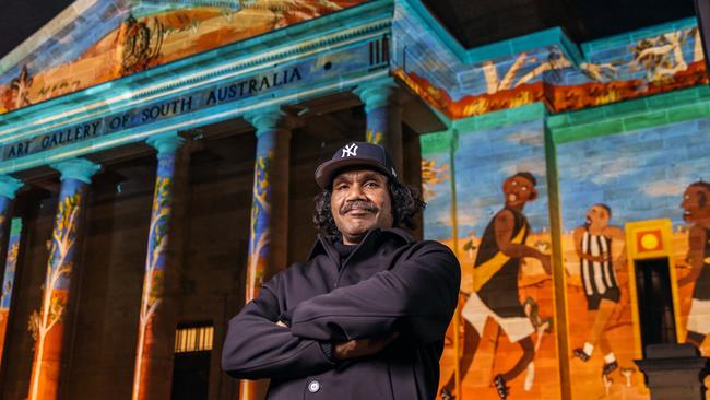 Artist Vincent Namatjira with his work Going Out Bush, projected on the Art Gallery of South Australia facade. Photo: Sia Duff