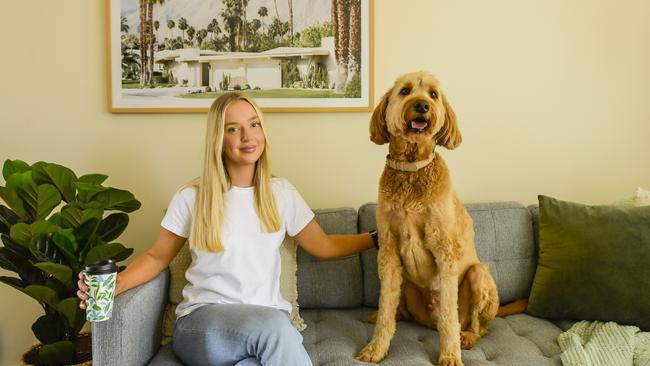 Hannah Agus with her dog, Leo at her Edwardstown home she bought through HomeStart. Picture: Roy VanDerVegt