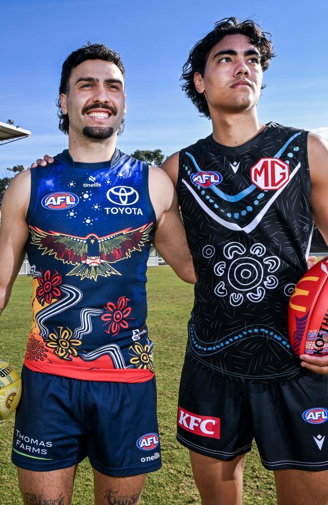 Izak Rankine of the Crows and Jase Burgoyne of the Power pose in their Indigenous guernseys. Picture: Mark Brake/AFL Photos/via Getty Images.