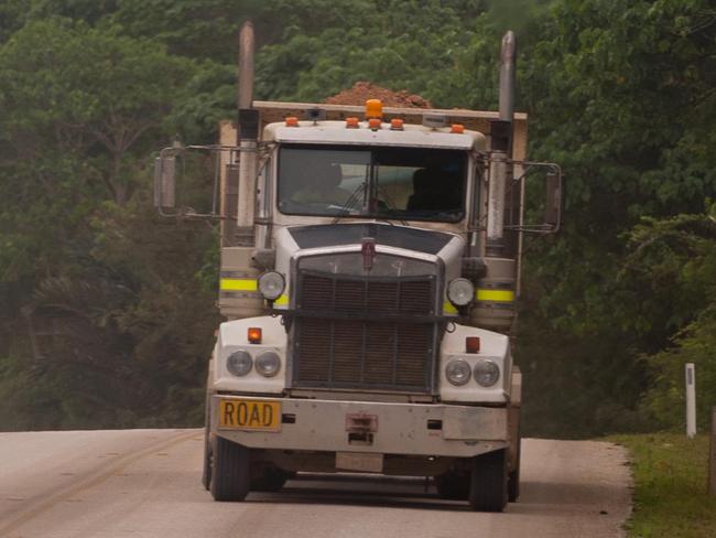 Christmas Island Phosphates trucks pass each other as they move to and from Phosphate Hill on Christmas Island, Territory of Christmas Island, Friday, Aug. 16, 2013. Phosphate mining, once the main area of economic activity, recommenced in 1991, mining the stockpile of the mineral.  (AAP Image/John Pryke) NO ARCHIVING