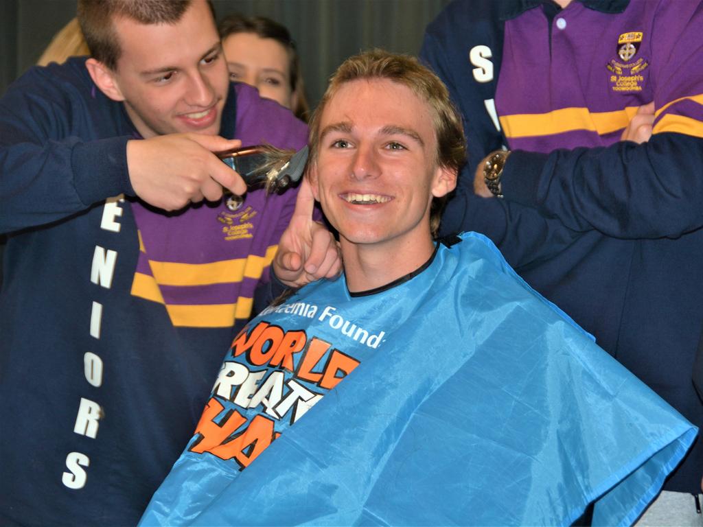 At the St Joseph's College 2023 World's Greatest Shave event is student Charlie Kruger having his hair cut by friends. Picture: Rhylea Millar