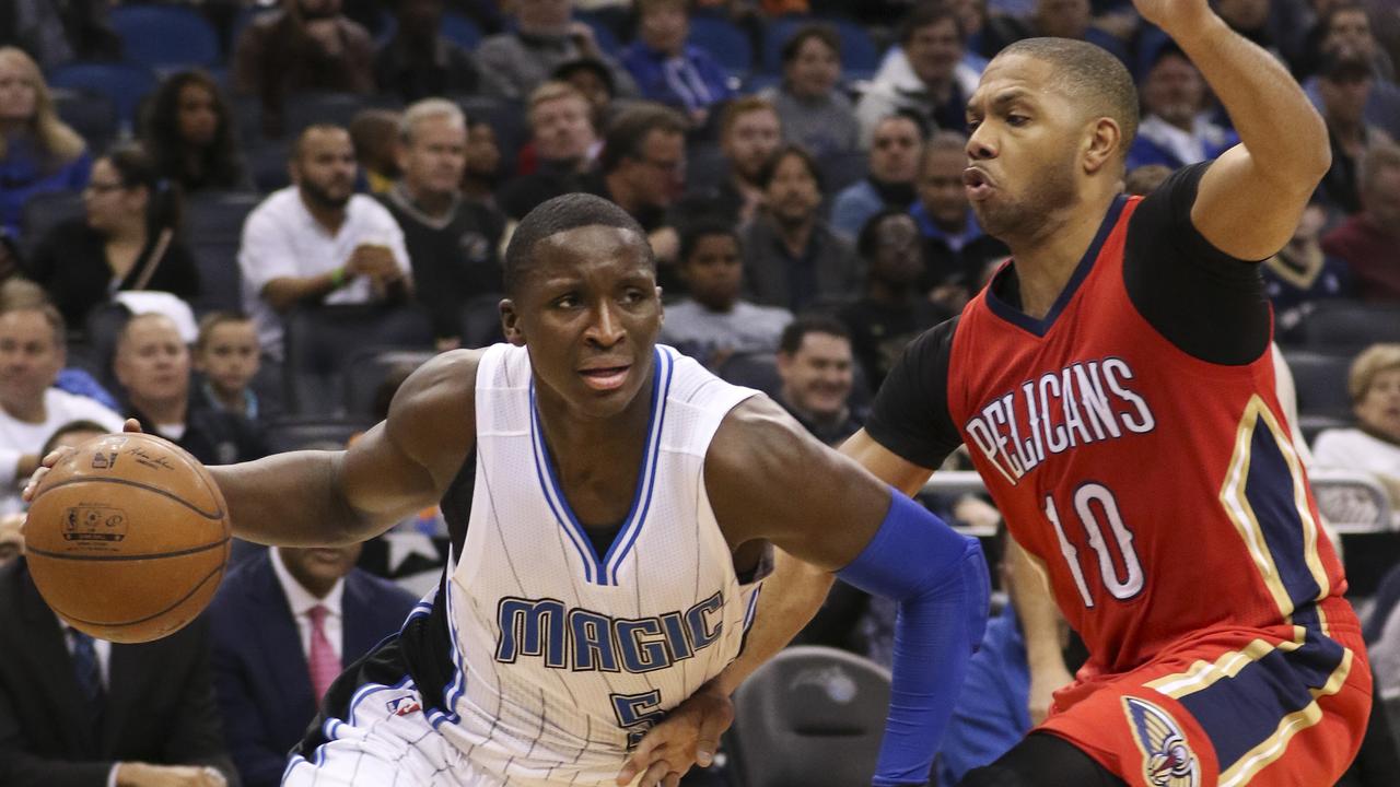 Orlando Magic guard Victor Oladipo (5) drives past New Orleans Pelicans guard Eric Gordon (10) during the first half of an NBA basketball game in Orlando, Fla., Friday, Feb. 20, 2015. (AP Photo/Reinhold Matay)