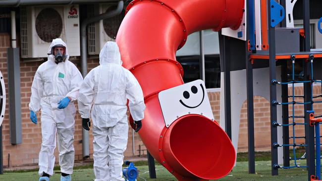 Cleaners in white Hazmat suits wearing protective masks were seen wiping every surface in the school playground. Photo: Adam Yip