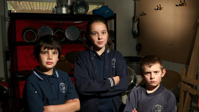 Kinglake West Primary School students Sonny, Camryn and Cohen were left without any musical instruments after thieves targeted the school three times. Picture: Hamish Blair