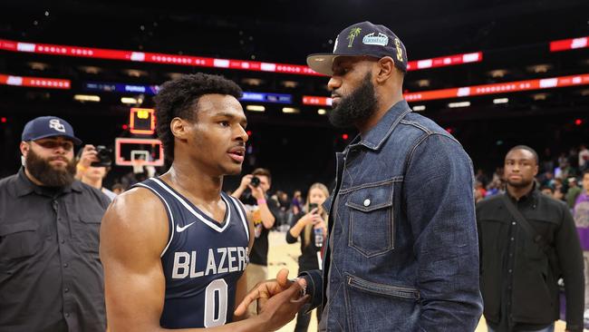 (FILES) In this file photo taken on December 11, 2021 Bronny James #0 of the Sierra Canyon Trailblazers is greeted by his father and NBA player LeBron James after defeating the the Perry Pumas in the Hoophall West tournament at Footprint Center in Phoenix, Arizona. – LeBron James has agreed to terms on a two-year NBA contract extension with the Los Angeles Lakers worth $97.1 million, according to multiple reports on Wednesday. (Photo by Christian Petersen / GETTY IMAGES NORTH AMERICA / AFP)