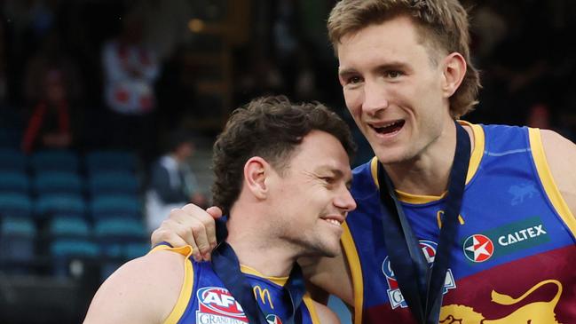 Brisbane Lions captains Lachie Neale and Harris Andrews together on the dais after winning the 2024 AFL Premiership. Picture Lachie Millard