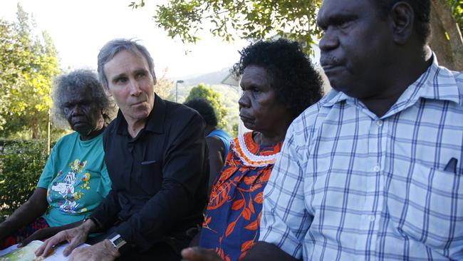 Traditional land owners of Aurukun, Aunty Martha Koowarta (left) and Dorothy Pootchemunka, and Mayor of Aurukun Neville Pootchemunka (right) talk with Greg McIntyre SC.