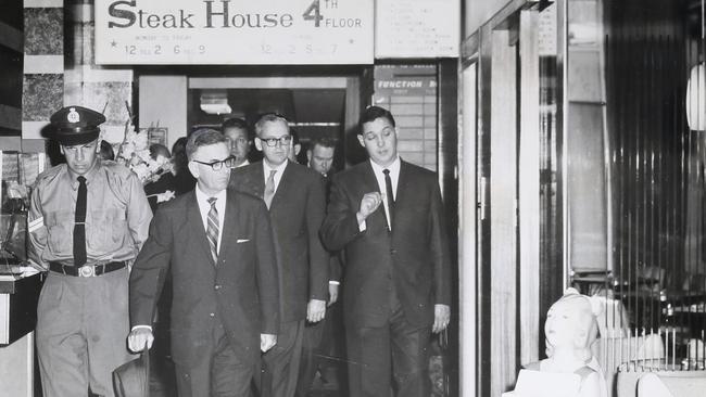 Royal Commissioner Justice Harry Gibbs (second from right) spent 30 minutes inspecting the National Hotel with Maxwell James Roberts, nominee of the licence (right), and his counsel Mr J.D. McGill QC in November 1963.