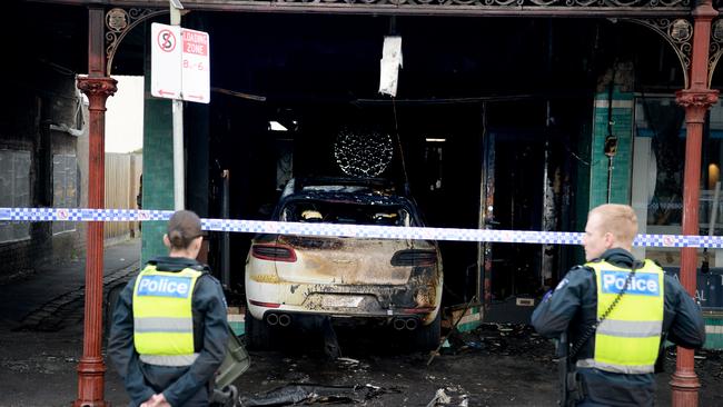 Both the car and the shop have been left totally destroyed by the fire, with a resident living above the store having to self-evacuate. Picture: Andrew Henshaw / NewsWire