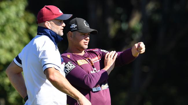 Former Broncos player and Queensland Reds defensive coach Peter Ryan (left) and Broncos coach Anthony Seibold (right) are seen during Brisbane Broncos training at Clive Berghofer Field in Brisbane, Tuesday, July 23, 2019. The Broncos are playing the Gold Coast Titans in their round 19 NRL clash on the Gold Coast on Saturday. (AAP Image/Darren England) NO ARCHIVING