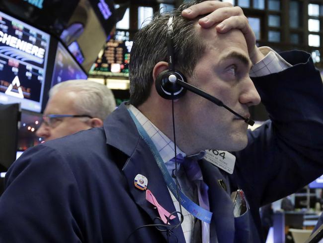 FILE - In this Wednesday, Jan. 6, 2016, file photo, trader Gregory Rowe works on the floor of the New York Stock Exchange, as stocks are opening lower as investors fret about signs of belligerence in North Korea and more weakening of China's economy. Tumult in China triggered the worst opening week for U.S. stocks in history, and investors could get plenty more to worry about in the following week. (AP Photo/Richard Drew, File)