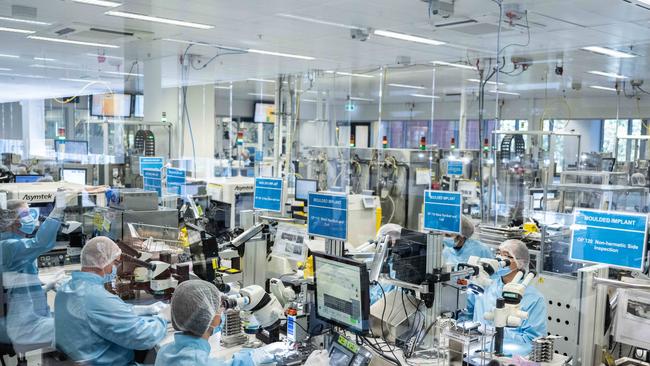 Workers on the production line building hearing Implants at Cochlear in Sydney. Picture: James Gourley