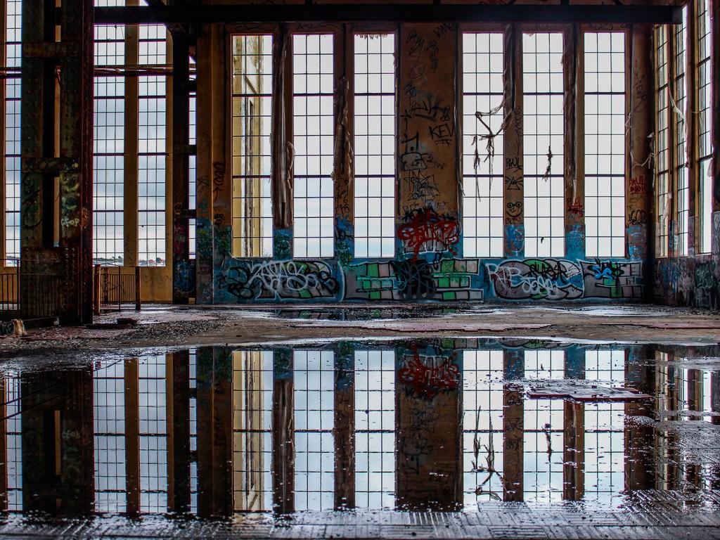 Corey Kirwen from Kinross (WA) Mindarie Senior College Memories reflected in forgotten halls “A very graphic story of light, shade and abandonment. Placement of the heavier elements is just right to give balance. The graffiti has enough tone to make it eye-catching. The reflection in the pool has some lovely tones. Nicely photographed!” Picture: 2015 Canon Light Awards