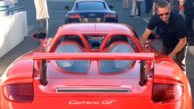 Paul Walker with the Porsche Carrera GY that he was killed in when it crashed and burst into flames.