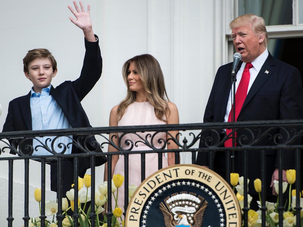 Barron Trump, 13, towers over his parents Donald and Melania | Herald Sun