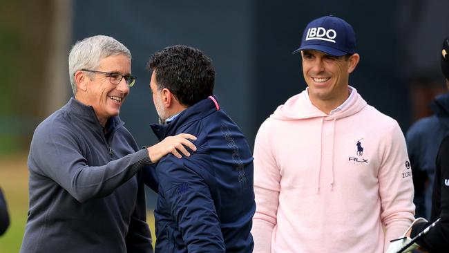 Jay Monahan and Yassir Al-Rumayyan meet each other as playing partners. (Photo by David Cannon/Getty Images)