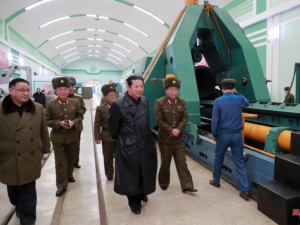 North Korean leader Kim Jong-un inspecting a munitions factory producing a major weapon system at an undisclosed location.