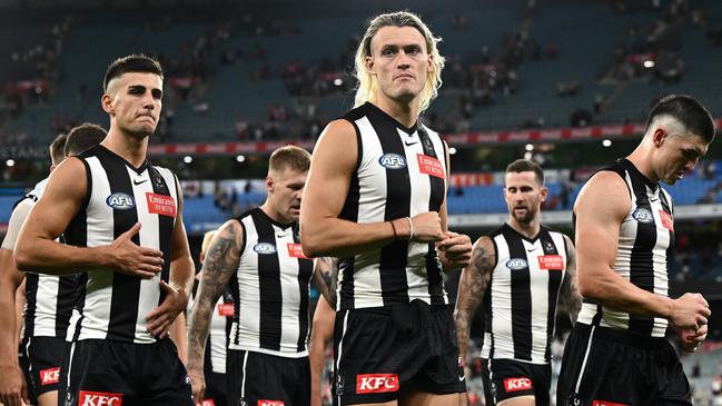 MELBOURNE, AUSTRALIA - MARCH 15: The Magpies look dejected after losing the round one AFL match between Collingwood Magpies and Sydney Swans at Melbourne Cricket Ground, on March 15, 2024, in Melbourne, Australia. (Photo by Quinn Rooney/Getty Images)