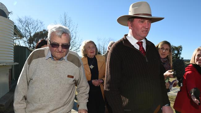 Barnaby Joyce arrives with his father James, left, and his mother Marie, to cast his vote for the seat of New England at Woolbrook public school in the July 2 election last year.