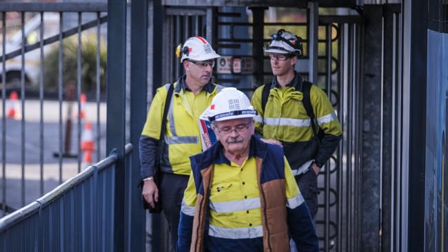 Workers leave the TEMCO manganese smelter at Bell Bay. Their futures at the plant are uncertain.