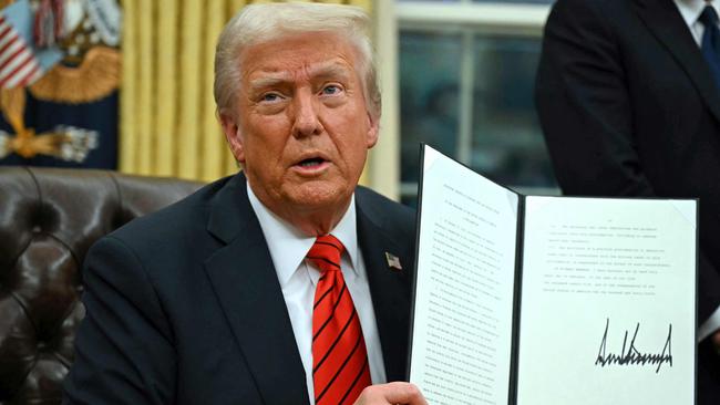 TOPSHOT - US President Donald Trump signs an executive order in the Oval Office of the White House on February 10, 2025, in Washington, DC. (Photo by ANDREW CABALLERO-REYNOLDS / AFP)