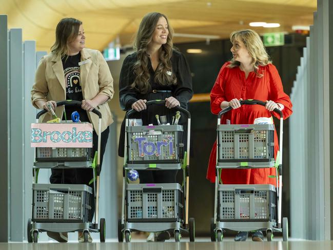 Teachers Brooke Bourgeois, Tori Julian and Becky Hall wheeling their trolleys containing the contents of their classroom. Picture: Wayne Taylor