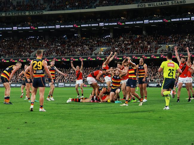 ADELAIDE, AUSTRALIA - APRIL 19: The Crows react as The Bombers celebrate their win during the 2024 AFL Round 06 match between the Adelaide Crows and the Essendon Bombers at Adelaide Oval on April 19, 2024 in Adelaide, Australia. (Photo by James Elsby/AFL Photos via Getty Images)