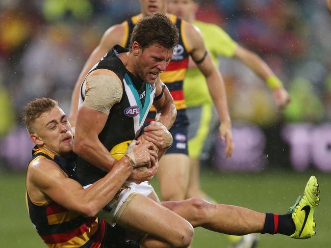 ADELAIDE, AUSTRALIA - AUGUST 06: Hugh Greenwood of the Crows is tackled by Brad Ebert of the Power during the 2017 AFL round 20 match between the Adelaide Crows and the Port Adelaide Power at Adelaide Oval on August 06, 2017 in Adelaide, Australia. (Photo by James Elsby/AFL Media/Getty Images)