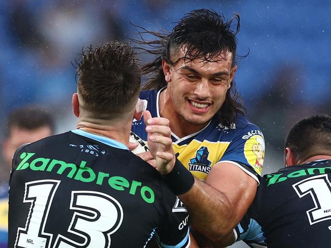 GOLD COAST, AUSTRALIA - MAY 22: Tino Fa'asuamaleaui of the Titans is tackled during the round 11 NRL match between the Gold Coast Titans and the Cronulla Sharks at Cbus Super Stadium, on May 22, 2022, in Gold Coast, Australia. (Photo by Chris Hyde/Getty Images)