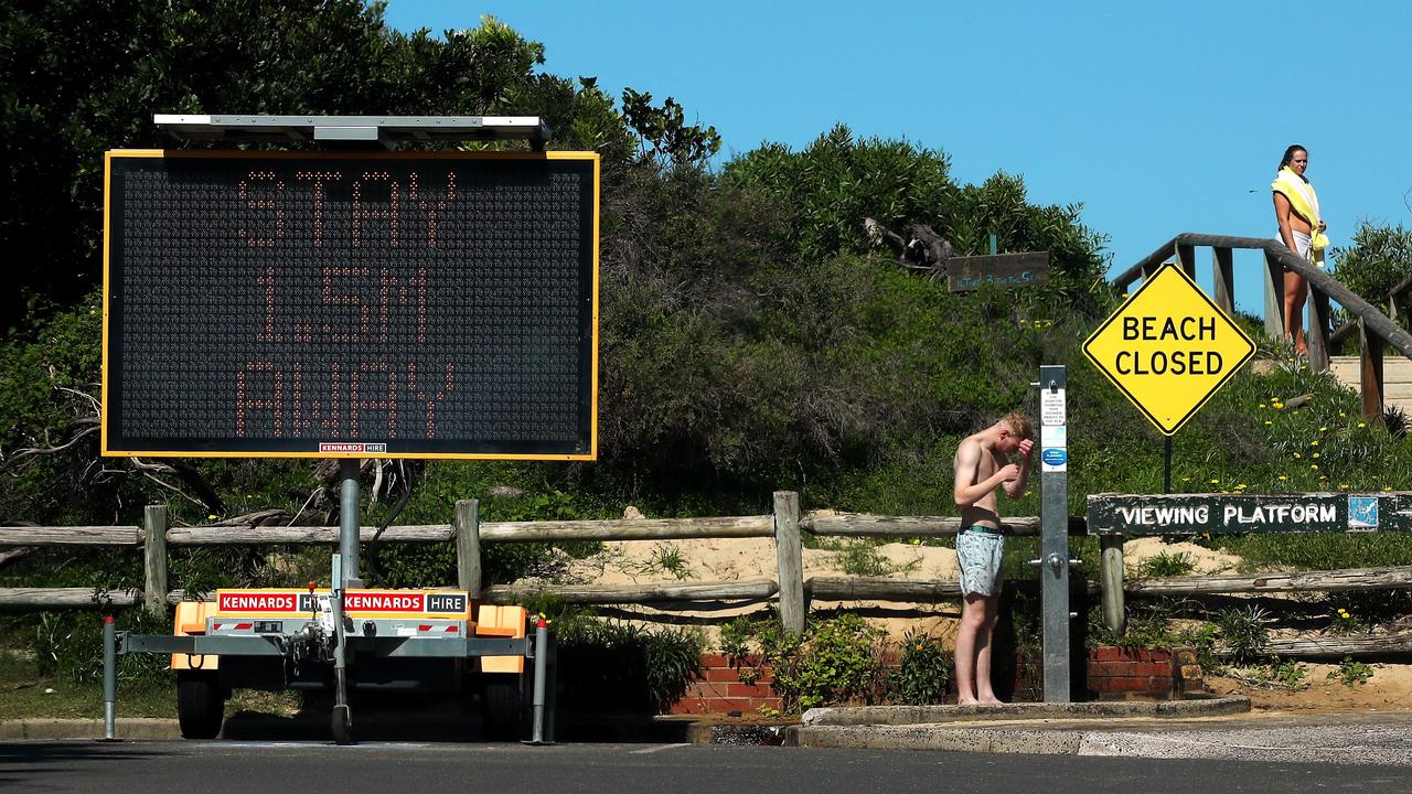 People shower at Freshwater Beach after it was closed. Cameron Spencer/Getty Images