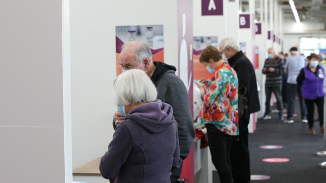 Signing in for a vaccine at Barwon Health's old Ford site hub. Picture: Alan Barber